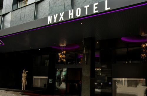 a msg hotel building with a cat in front of it at NYX Hotel Madrid by Leonardo Hotels in Madrid