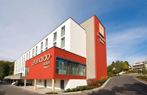 a hotel with a red and white building at Leonardo Hotel Völklingen-Saarbrücken in Völklingen