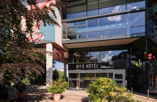 a building with a nx hotel sign in front of it at NYX Hotel Berlin Köpenick by Leonardo Hotels in Berlin