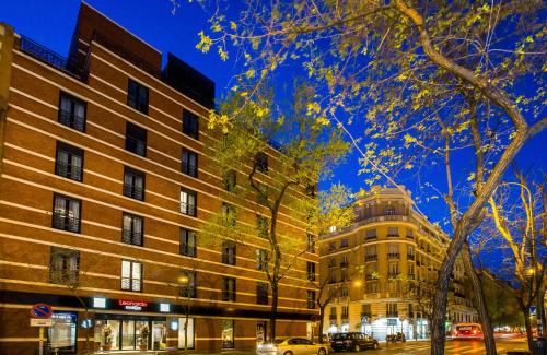 a building on a street next to a building at Leonardo Boutique Hotel Madrid in Madrid