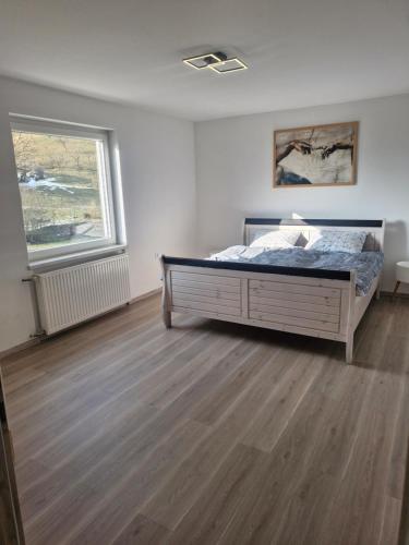 a bedroom with a bed and a window at Mirna zelena dolina in Šentilj