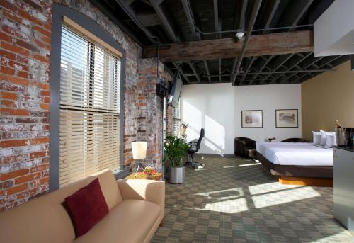 a bedroom with a bed and a brick wall at Sonesta Columbus Downtown in Columbus