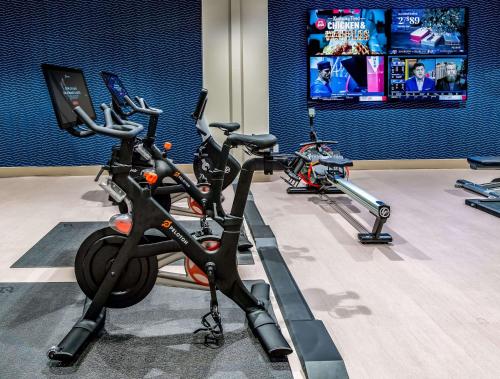 a gym with three exercise bikes parked in a room at Sonesta Columbus Downtown in Columbus