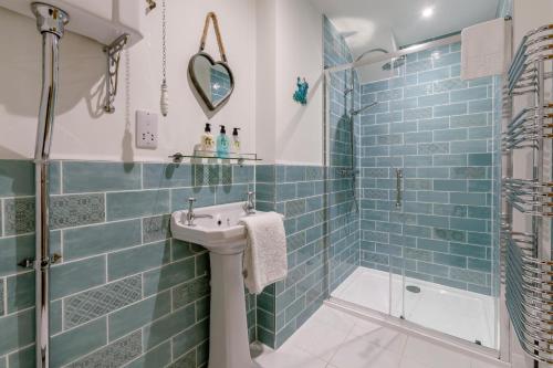 a bathroom with a sink and a shower at 5 Bed in Stibb oc-f31065 in Poughill