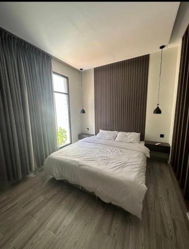 a bedroom with a large bed and a window at شاليهات سمو بارك in Taif