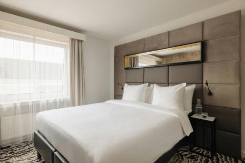 a bedroom with a large white bed and a window at Leonardo Boutique Hotel The Lancaster Amsterdam in Amsterdam