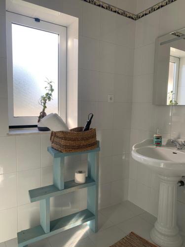a bathroom with a sink and a toilet and a window at Vagos Art.Lab in Vagos