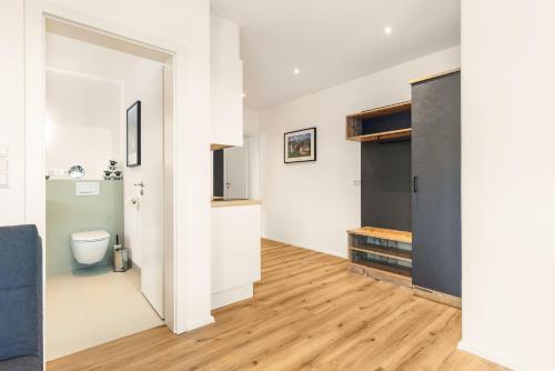 a bathroom with a toilet and a sink in a room at Alpen Lodge Samerberg in Samerberg