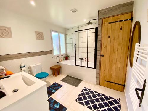 a bathroom with a sink and a toilet and a shower at St Pasha in Paillé