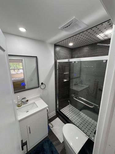 a bathroom with a shower and a toilet and a sink at Private Bedroom with Ensuite in Toronto