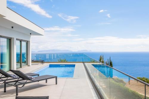 a house with a swimming pool and the ocean at Half Gate Villa - Ocean View & Private Pool in Gaula