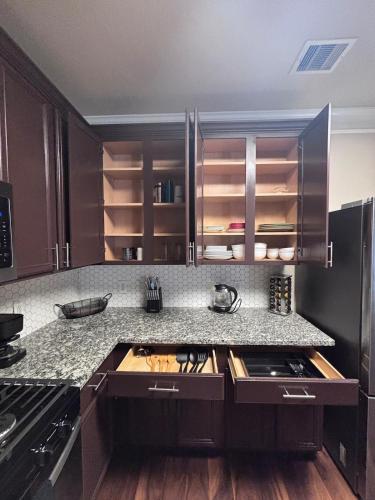 a kitchen with brown cabinets and a counter top at 5bd Beautiful Modern home in Spring in Spring