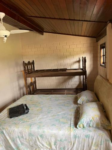 a bedroom with a bed and a bag on it at Sítio Ubaitaba in Boituva