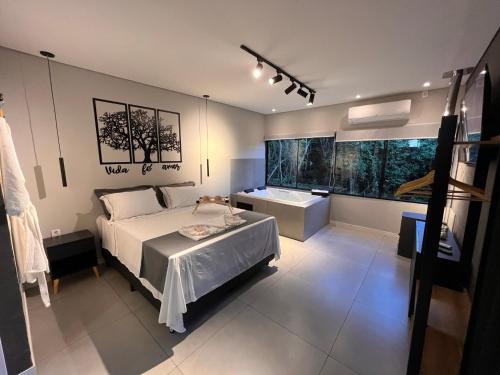 a bedroom with a bed and a sink in it at RASTRO Cabins in Restinga Sêca