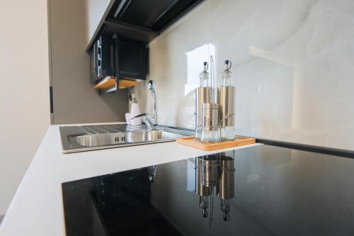 a kitchen with a sink and a counter top at ARQO Apartments in Marcianise