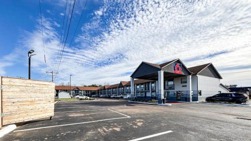 a building with a sign on it in a parking lot at Studio 6 Suites - Richland, MS - Jackson in Richland