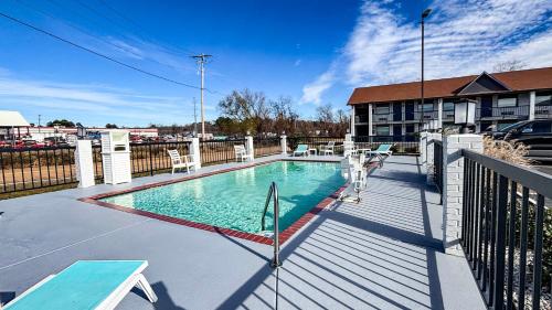 a swimming pool on a balcony of a building at Studio 6 Suites - Richland, MS - Jackson in Richland