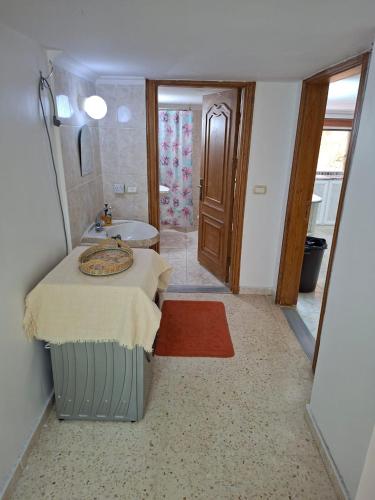 a bathroom with a bed and a sink and a tub at Mountain Pad Overlooking Jerash - HQ Budget stay in Jerash