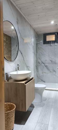 a bathroom with a sink and a toilet and a mirror at The Zephyr House -2- in Pyrgos