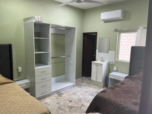 a room with a bedroom with a bed and a bathroom at CASA DE LA ABUELa in Colima