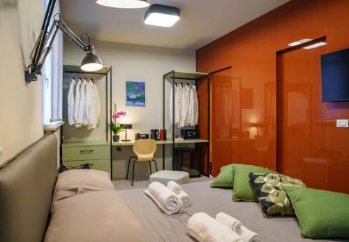 a bedroom with a bed and a desk in it at JDN Rooms in San Donato Milanese