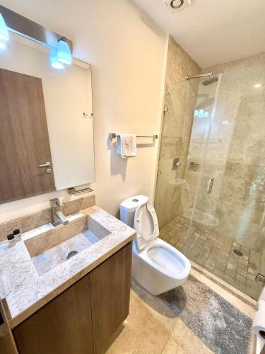 ein Badezimmer mit Waschbecken, Toilette und Dusche in der Unterkunft Central 102 Malecón in Mazatlán
