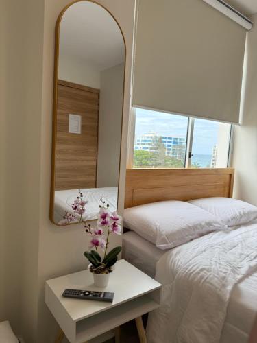 a bedroom with a bed and a mirror and a table at Suite For You - Salinas Chipipe in Salinas