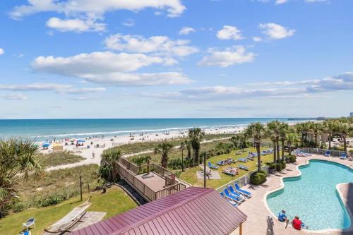a view of the beach and a swimming pool at a resort at Camelot by the Sea Oceanfront 2BR in Myrtle Beach