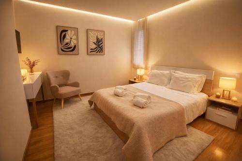 a bedroom with a bed and a desk and a chair at Almeida's House in Viana do Castelo