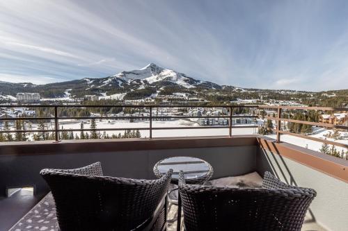 a balcony with a view of a snow covered mountain at North Summit in Big Sky