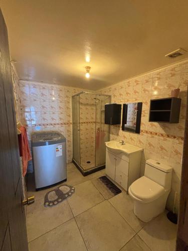 a bathroom with a toilet and a shower at Refugio Costero in Caldera