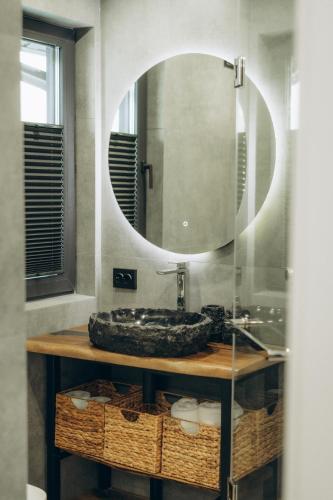 a bathroom with a sink with a large mirror at Zarichna Cottage in Podgorodtsy