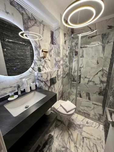 a bathroom with a sink and a toilet and a shower at MavCity Boutique in Constanţa