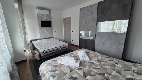 a bedroom with a bed and a television in it at Giulietta Apartment Cuneo in Cuneo