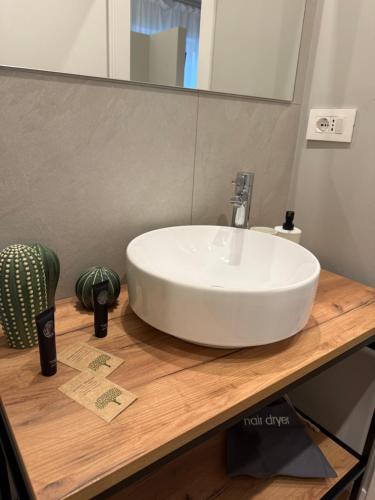 a white sink on a wooden counter in a bathroom at Stelle di Verona - Rigel in Verona