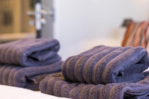 a pile of purple towels sitting on a table at Lewis Living in Isle of Lewis