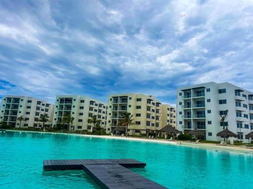 a swimming pool in front of some apartment buildings at Premium apartment in Laguna Playa with pool in Mazatlán