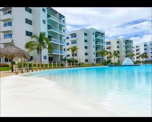 a large swimming pool in front of some apartment buildings at Premium apartment in Laguna Playa with pool in Mazatlán