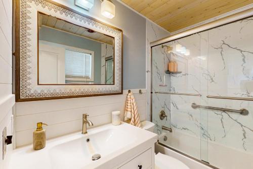 a bathroom with a sink and a shower and a mirror at Sun Mark 253 in Ocean City