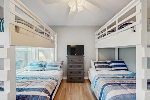 a bedroom with two beds and a tv in it at The Lazy Oak Retreat in Rockport