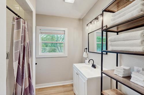 a bathroom with a sink and a mirror at The Lazy Oak Retreat in Rockport