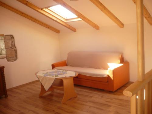 a small room with a bed and a table at House Dragica in Cres