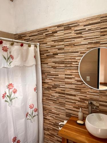 a bathroom with a shower curtain and a sink at Max in El Chalten
