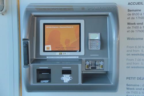 an atm machine with a picture of a woman at Premiere Classe Soissons in Soissons