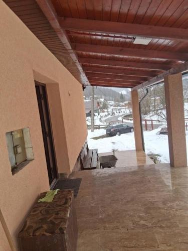 a porch of a building with snow on the ground at Colț de Rai in Gara Bucureşti Progresu