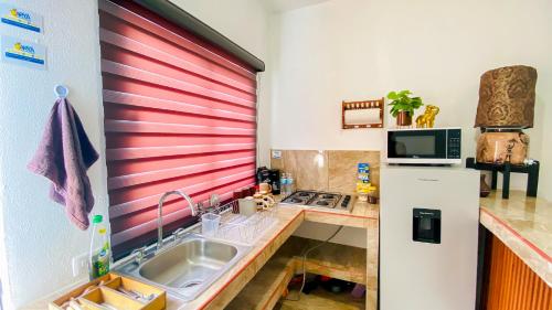 a kitchen with a sink and a refrigerator at Depa Altavela en Bahía, Hospital IMSS 33 muy cerca in Mezcales