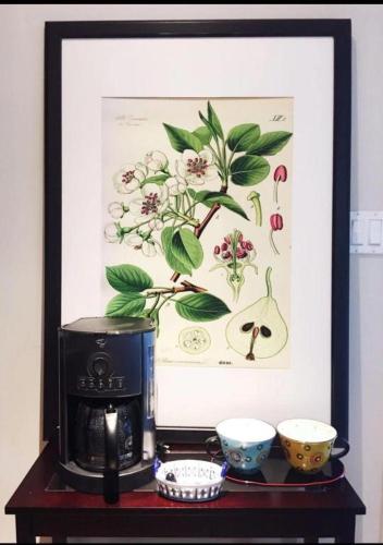 a picture of a coffee maker and bowls on a table at Dunbar Home in Vancouver