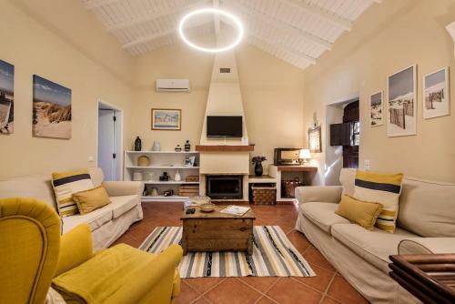 a living room with two couches and a tv at Family & Friends Retreat w/ Pool - Moncarapacho in Tavira