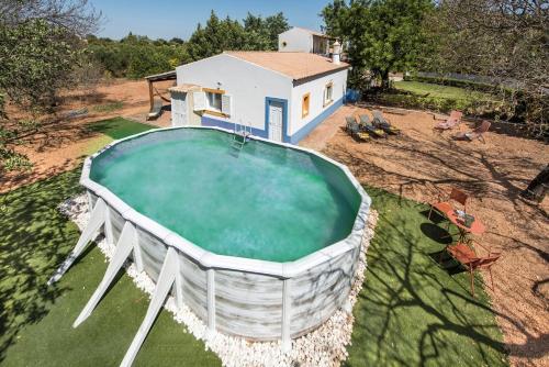 an overhead view of a large swimming pool in front of a house at Family & Friends Retreat w/ Pool - Moncarapacho in Tavira