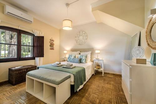 a bedroom with a large bed and a window at Family & Friends Retreat w/ Pool - Moncarapacho in Tavira